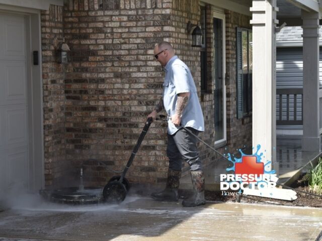 pressure doctor professional pressure washing concrete in front of brick home Indianapolis, IN