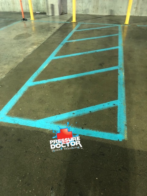 parking garage after concrete cleaned with pressure doctor logo