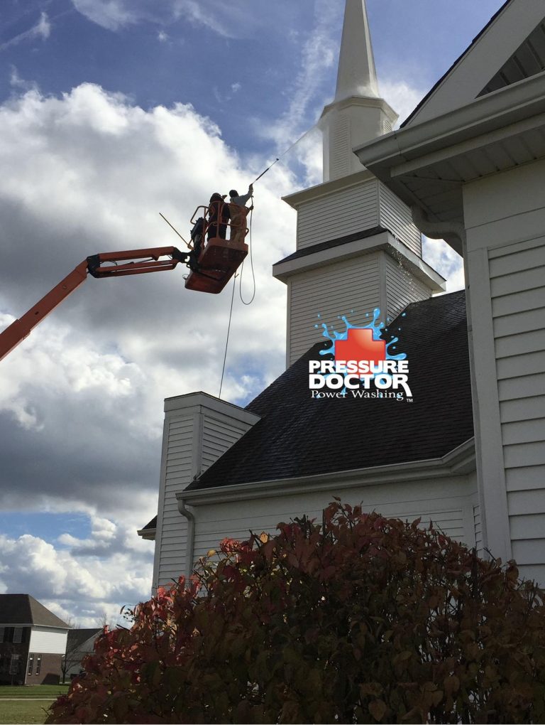 pressure doctor professionals cleaning white church with pressure doctor logo