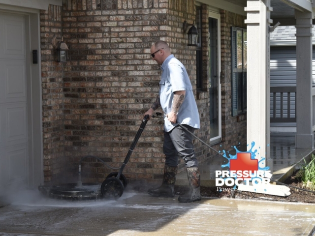 pressure doctor professional pressure washing concrete in front of brick home Indianapolis, IN