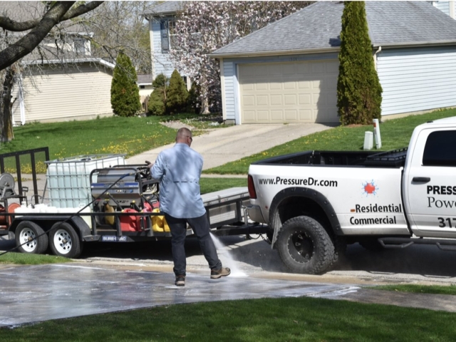 Pressure Doctor employee cleaning concrete Indianapolis, IN