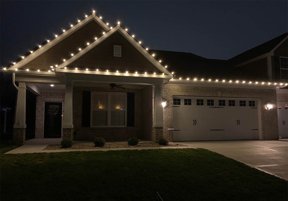 brick house with white Christmas lights