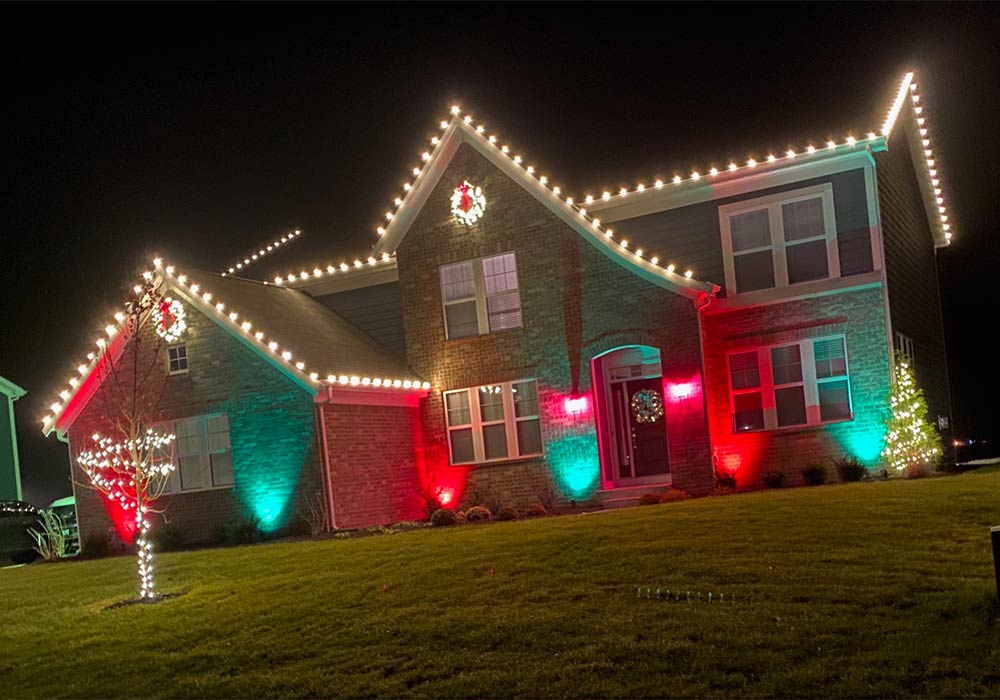 brick house with red, green, and white Christmas lights