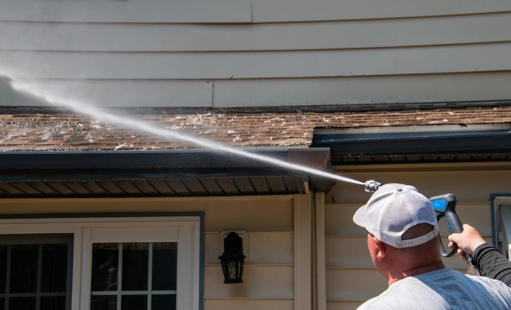 pressure doctor professional in white hat pressure washing roof